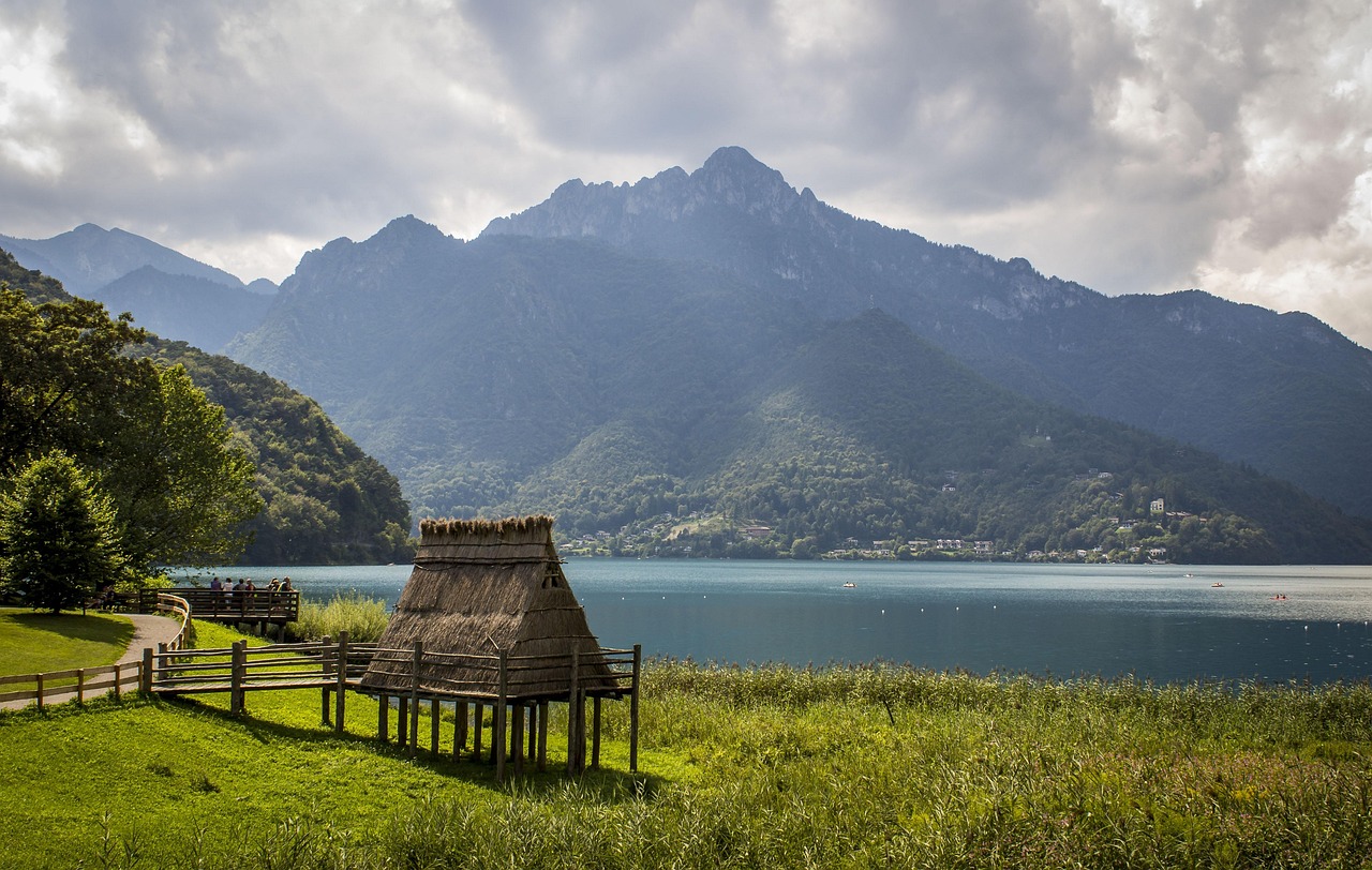 Lago italiano con acque cristalline circondato da montagne, simile a un fiordo norvegese.
